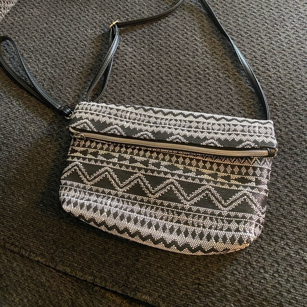 Black/ white wristlet/ shoulder strap, zipper pocket inside